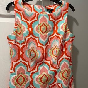 Sleeveless aqua, pink, orange dress.